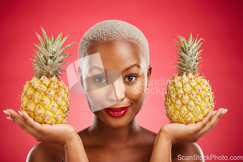 Image of Woman, pineapple and studio portrait for skincare, beauty and diet for wellness, health and red background. African model girl, fruits and face with makeup, nutrition and food choice with cosmetics