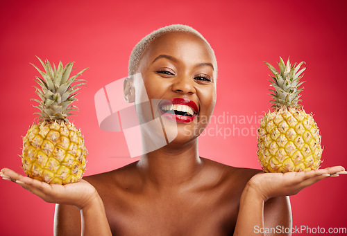 Image of Beauty, pineapple and portrait of a woman in studio for healthy food, diet or fruit. Black person with makeup on red background for face glow, natural cosmetics and tropical skin care or wellness