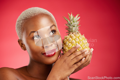 Image of Thinking, pineapple and face of a woman in studio for healthy food, diet or fruit. Black female model with makeup on red background for wellness glow, natural cosmetics and skin care or beauty