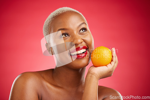 Image of Orange, thinking and black woman with skincare, cosmetics and vitamin c on a red studio background. Female person, ideas and model with citrus fruit, makeup and wellness with natural beauty and detox