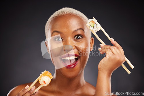 Image of Woman, portrait and sushi surprise with chopsticks in studio for healthy eating, beauty and food. Face of a happy black person with makeup on a dark background for diet, wow or seafood advertising