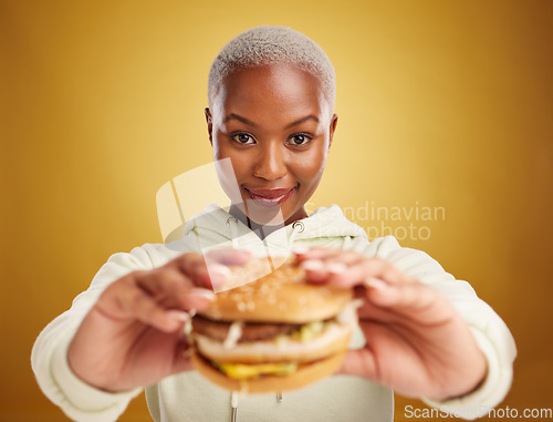 Image of Burger, offer and portrait of woman or student on studio yellow background in restaurant promotion or deal. Giving, eating and young african person for customer experience with fast food or hamburger