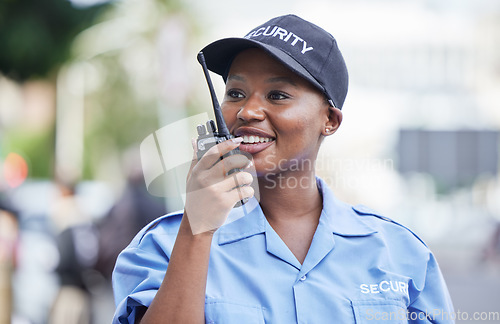 Image of Woman, security guard and radio in street, city and communication for contact, backup or safety with smile. African protection agent, audio tech and talk with info in metro, cbd or road to stop crime