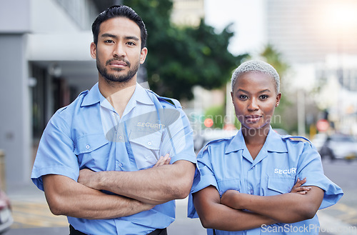 Image of Woman, man and security guard portrait in street, arms crossed or serious with support, safety or teamwork. Protection agent, smile and face for partnership, solidarity and pride for job in metro cbd