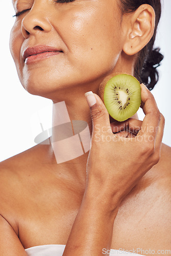 Image of Skincare, beauty and senior woman with kiwi in studio isolated on a transparent png background. Food, fruit and natural model with nutrition for wellness, healthy diet and vitamin c for anti aging.