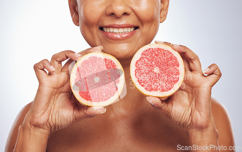Image of Skincare, hands and happy woman with grapefruit in studio isolated on a white background. Food, natural fruit and mature model with nutrition for wellness, healthy diet and vitamin c for anti aging.