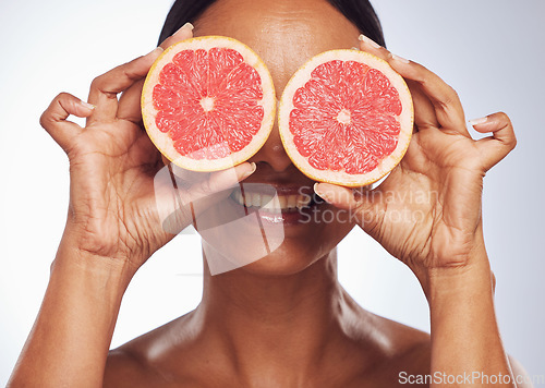 Image of Smile, face and senior woman with grapefruit in studio isolated on a white background. Skincare, natural fruit and happy model with food for nutrition, healthy diet and vitamin c for anti aging.