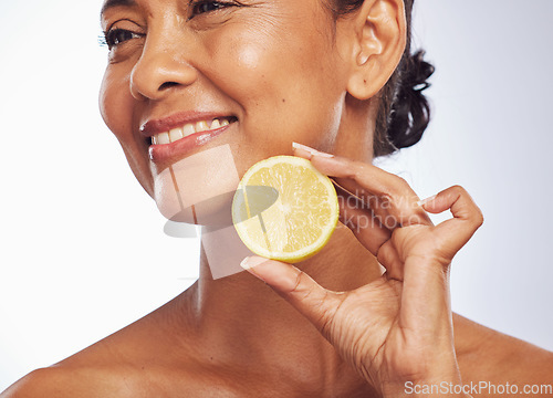 Image of Thinking, orange and senior woman with skincare, cosmetics and vitamin c against a white studio background. Mature female person, happy lady or model with citrus fruit, natural beauty and nutrition