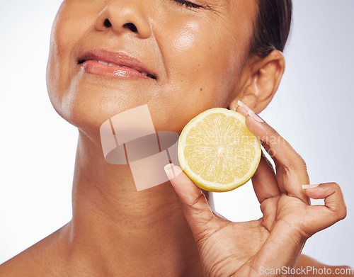 Image of Cosmetics, orange and senior woman with skincare, natural beauty and vitamin c on a white studio background. Mature female person, self care and model with citrus fruit, natural beauty and wellness