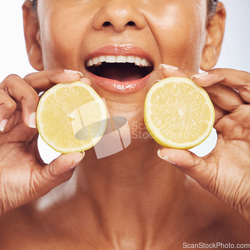 Image of Closeup, orange and senior woman with skincare, cosmetics and dermatology on a studio background. Zoom, female person or model with citrus fruit, treatment and natural beauty with vitamin c or health
