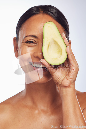 Image of Face, skincare and senior woman with avocado in studio isolated on a white background. Happy, natural fruit or portrait of mature model with food for nutrition, healthy diet or omega 3 for anti aging