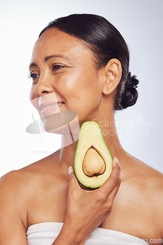 Image of Avocado, skincare or happy mature woman with fruit for cleaning, detox or healthy skin with beauty. Wellness, white background or senior model smiling for natural dermatology treatment in studio