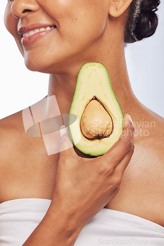 Image of Avocado, skincare or happy woman with fruit for natural cleaning, detox or healthy skin with beauty. Wellness, hand or closeup of model smiling in dermatology treatment in studio or white background