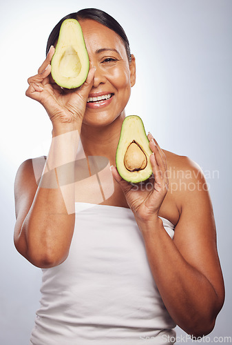 Image of Senior, health and portrait of woman with avocado for skincare, nutrition or diet. Happy, face and elderly model or lady with food for wellness, beauty and detox isolated on a studio background