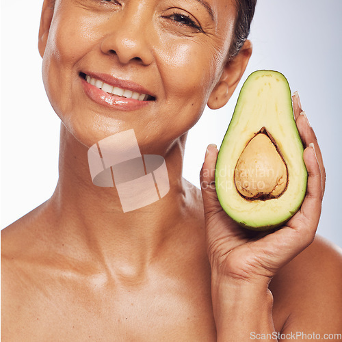 Image of Skincare, face and mature woman with avocado in studio isolated on a white background. Portrait, natural fruit and happy model with food for organic nutrition, healthy diet and omega 3 for anti aging