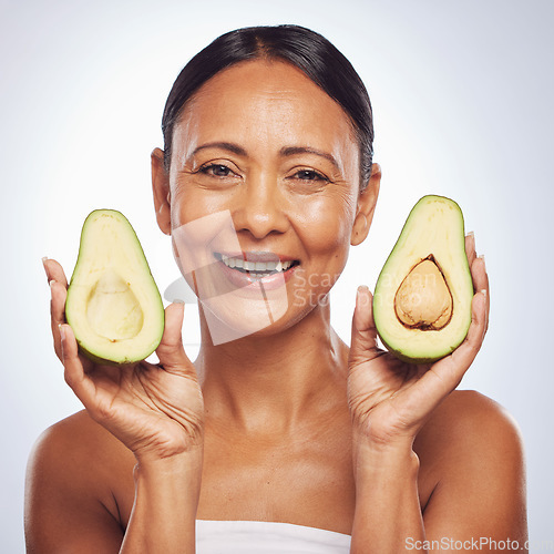 Image of Avocado, portrait and beauty of woman in studio, white background and face glow. Happy mature model, natural skincare and fruits for sustainable cosmetics, vegan dermatology and facial benefits