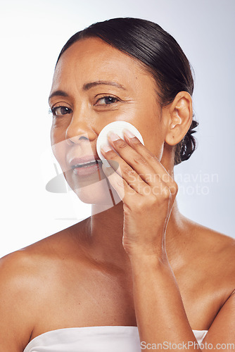 Image of Skincare, senior or woman portrait with cotton pad for dermatology, wellness or healthy facial skin. Studio background, glow or face of mature person with swab for beauty, cleansing or dirt removal