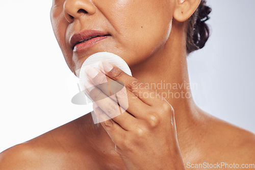 Image of Skincare, closeup or woman with cotton pad for dermatology, wellness or healthy facial skin. White background, hand or face of person cleaning with swab for beauty shine, cleansing or dirt removal