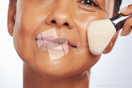 Image of Brush, portrait or senior woman in studio for cosmetics powder, beauty or facial grooming treatment. White background, senior or face of mature model applying foundation product in self care routine