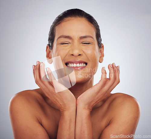 Image of Happy, skincare and woman with hands for beauty, glow or wellness from dermatology. Smile, facial and excited model or person with anti aging treatment for cosmetics isolated on a studio background