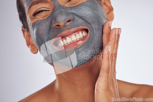 Image of Happy woman, charcoal mask and face for beauty on studio background. Mature female model smile with clay skincare product, facial cosmetics or aesthetic makeup for dermatology, collagen and self care