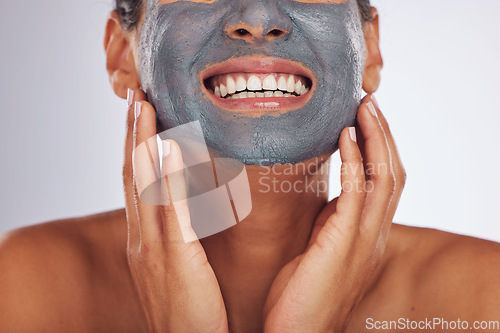 Image of Woman, smile and charcoal mask on face for beauty, aesthetic dermatology or self care on white background in studio. Closeup of happy female model with clay skincare product, facial cosmetics or glow