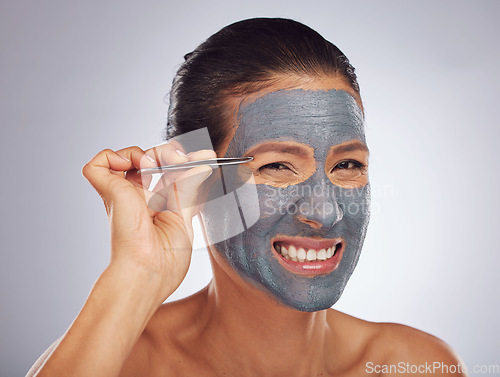 Image of Portrait, eyebrow tweezers and a woman with a face mask for skincare, grooming and female beauty. Sore, cosmetics and a model with gear for hair and a facial isolated on a white background in studio