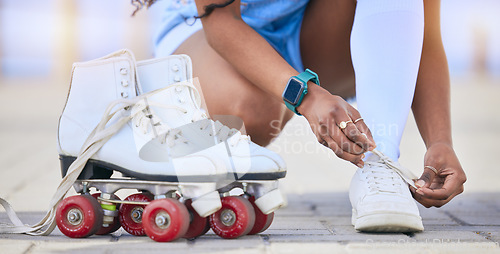 Image of Hands, roller skates and tie shoes on street to start exercise, workout or training outdoor. Skating, person and tying sneakers to get ready for sports on road to travel, journey and fitness practice