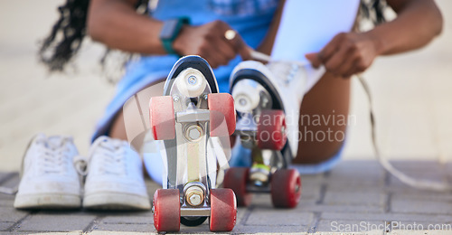 Image of Roller skates, hands and tie shoes on the ground to start exercise, workout or training outdoor. Skating, person and tying laces to get ready for sports on street to travel, journey and fitness.