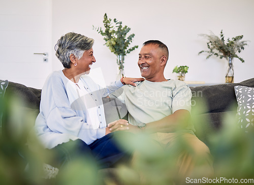 Image of Love, happy and laughing elderly couple relax, speaking and enjoy funny conversation, care or chat in home apartment. Holding hands, comedy and senior woman, man or people laugh at relationship joke