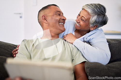 Image of Love, tablet and happy senior couple bonding, relax and check email, news article and enjoy retirement eye contact. Website story, online shopping and elderly man, old woman or people smile at home