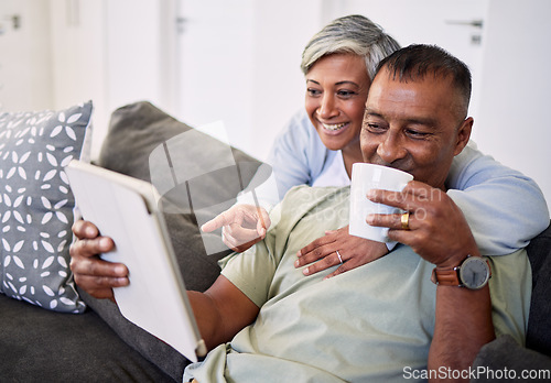 Image of Home, tablet and happy senior couple on sofa, relax and check email, news article and point at online shopping choice. Website info, decision or elderly man, old woman or people smile in living room