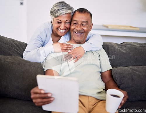 Image of Video call, happy and senior couple with a tablet on a sofa while relaxing and bonding together. Smile, love and elderly man and woman in retirement on a virtual conversation with digital technology.