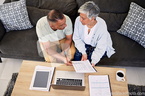 Image of Senior couple, tax documents and laptop in home living room for discussion, planning and finance. Elderly man, old woman and paperwork for financial compliance in top view, lounge sofa and retirement