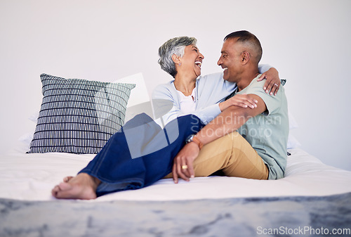 Image of Hug, bedroom and laughing senior couple bonding, talking and enjoy quality time, funny conversation or trust. Morning discussion, marriage humour and relax elderly people laugh at comedy joke on bed