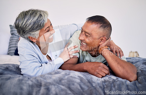 Image of Love, bedroom and laughing senior couple bonding, happy and enjoy quality time together, funny conversation or comedy. Smile, marriage humour and relax elderly people laugh at retirement joke on bed