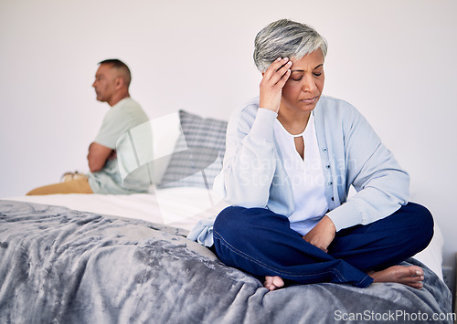 Image of Angry, divorce and a senior couple in the bedroom for a fight, sad and depression in marriage. Stress, mental health and an elderly woman with anxiety about a problem with a man on a bed for conflict