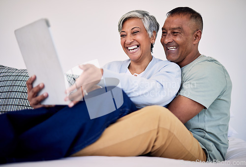 Image of Bed, tablet and happy elderly couple laughing at funny social network blog, email or watch comedy video, podcast or meme. Funny morning article, home bedroom and senior people laugh, bond and hug