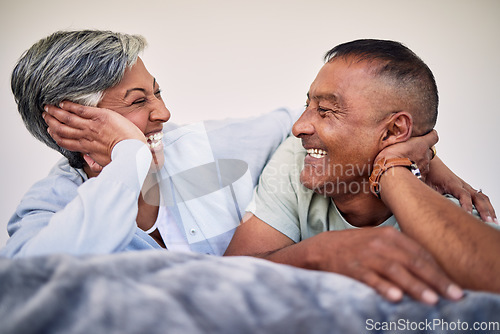 Image of Love, bedroom face and elderly couple laugh, bond and enjoy quality time together, funny conversation and relax. Home rest, marriage care or senior woman, old man or retirement people laughing in bed