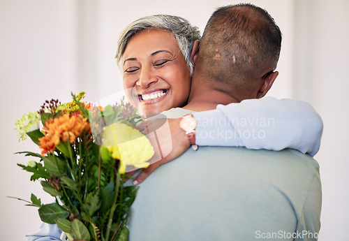 Image of Flower bouquet, elderly couple hug or gift for happy anniversary, special event or marriage love, care and support. Home bond, sorry and elderly woman, man or excited people smile with floral present