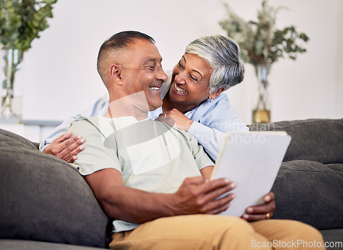 Image of Love, happy and senior couple with tablet on the sofa networking on social media or the internet. Smile, relax and elderly man and woman in retirement networking on digital technology in living room.