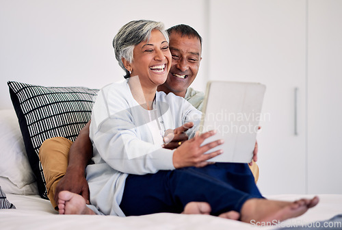 Image of Happiness, bedroom tablet and elderly couple laughing at funny social media meme, comic or streaming comedy video. Funny morning news article, home bed and senior bonding people laugh at online joke