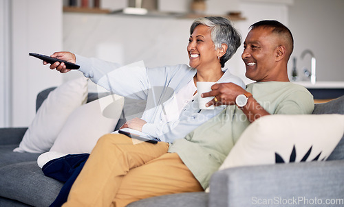 Image of Senior couple, watching tv and relax on couch in home living room, laugh and together for funny comedy show. Elderly man, old woman and remote control for video, comic movie and lounge sofa in house