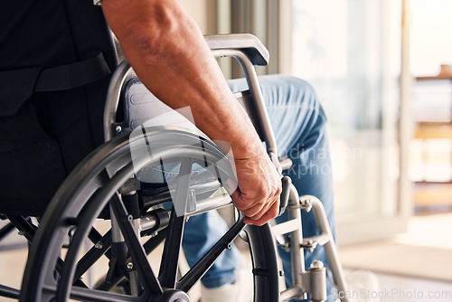 Image of Man, hands and wheelchair for support, hope or travel in healthcare or medicare at home. Closeup of male or person with a disability moving on chair for mobility, surgery or wellness in the house