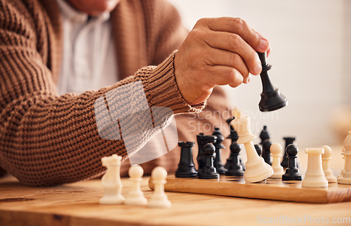 Image of Man, chess and hand for moving, game or competition with focus, strategy or problem solving at desk. Person, master and brain power for board contest, mindset or checkmate for winning, table or house