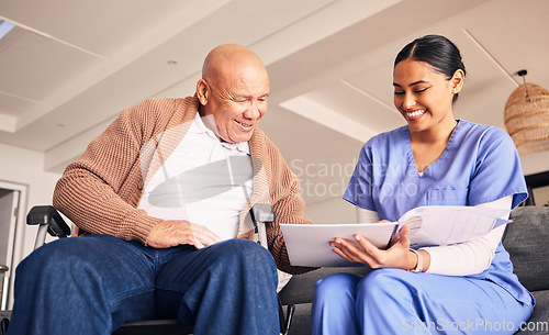 Image of Old man, wheelchair or caregiver reading documents, history or healthcare documents at nursing home. Smile, medical records or happy nurse showing senior patient or elderly person with a disability