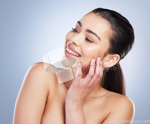 Image of Happy, thinking and a woman with skincare glow for wellness, beauty or cosmetics. Smile, idea and a young model or girl touching skin for clean feeling and dermatology isolated on a studio background