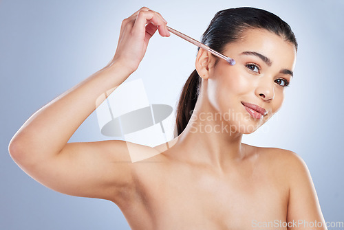 Image of Makeup, natural and woman with cosmetic brush in studio for beauty and glamour facial routine. Self care, young and portrait female model from Brazil with cosmetology face isolated by gray background