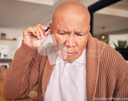 Image of Senior man, hand and hearing aid for ears, health and wellness for retirement in nursing home. Elderly person with disability, audio or sound technology to listen, medical help or innovation at house