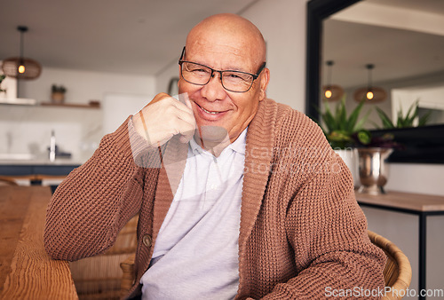 Image of Portrait, smile and glasses with a senior man sitting in the living room of his home during old age retirement. Relax, wrinkles and satisfaction with a happy elderly male pensioner in his house